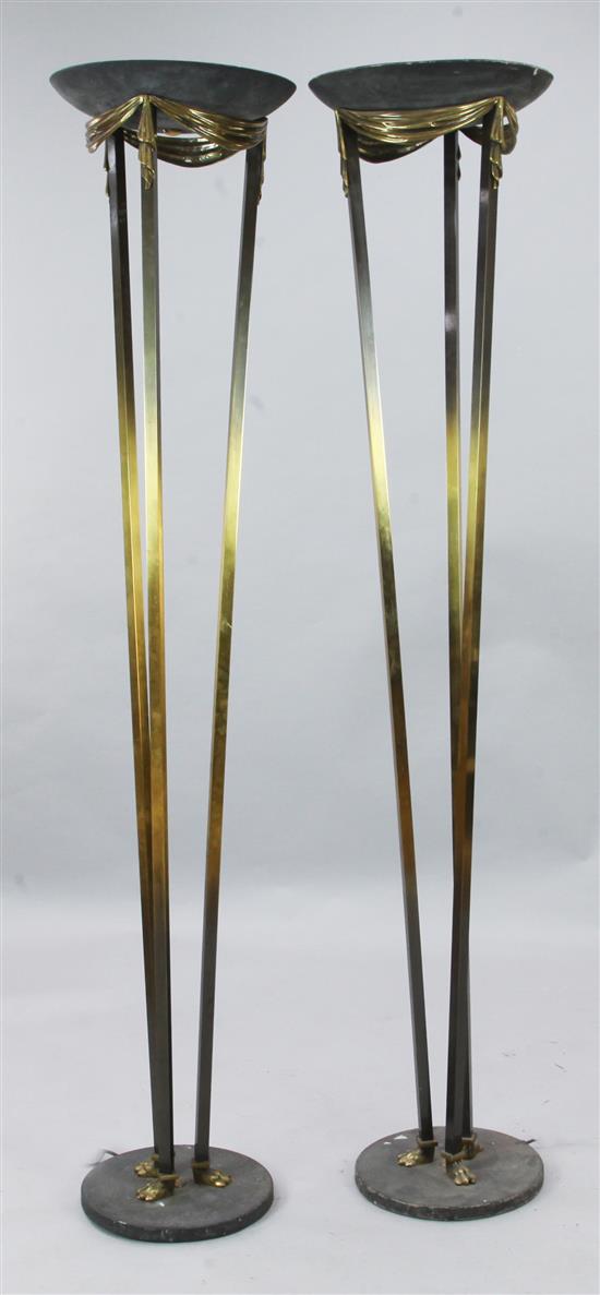 A pair of parcel ebonised brass uplighters, H.5ft 11in.